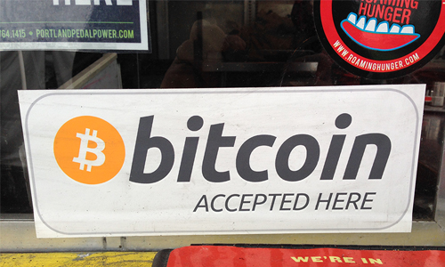 After peaking on Monday, Bitcoin is now on pace to have its worst week since 2015. (“bitcoin accepted here” by Flickr user Francis Storr, CC BY 2.0.)