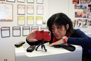 Government and Political Reporter Amy Wu makes a smartphone video.