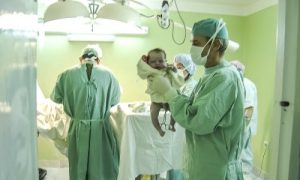 Doctor holding a newborn baby