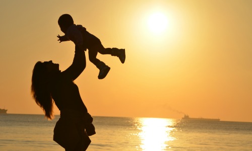 “Woman and child against a sunset” image via Pexels user Pixabay CC0 License 