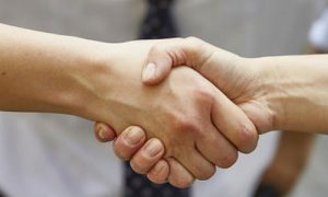 Trust is a the heart of the DOL's new fiduciary rule. Here are three big stories to develop for your readers. ("Handshake with smile" by Vilmos Vincze via Flicker, CC BY 2.0)