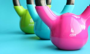 Multi-colored kettle bell weights in a row