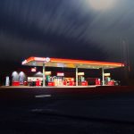 Gas station lit up at night time