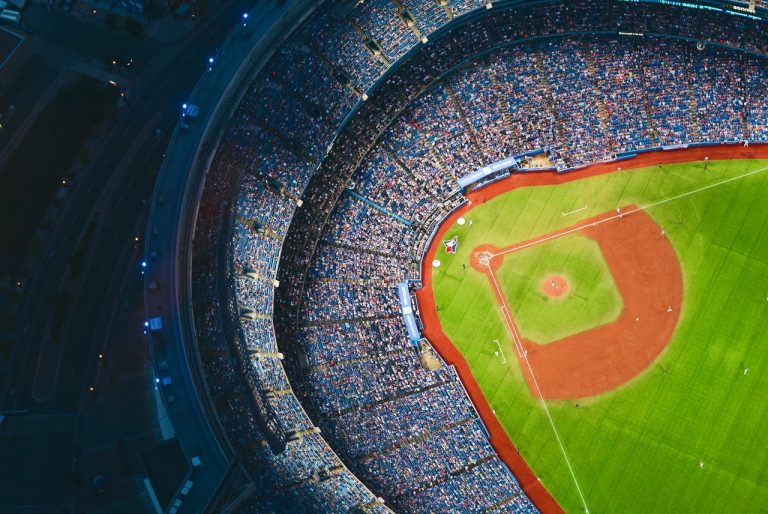 Aerial view of baseball stadium at night with stands full