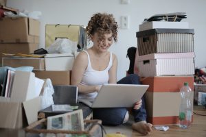woman on computer surrounded by boxes