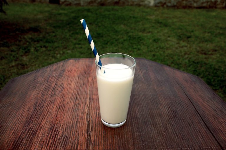 Glass of milk with striped straw