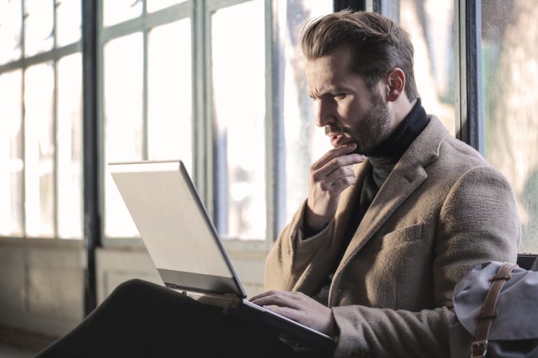 Man confused looking at computer