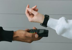 a person making a payment using their watch