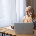 female talking on the phone taking notes