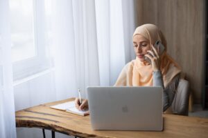 female talking on the phone taking notes