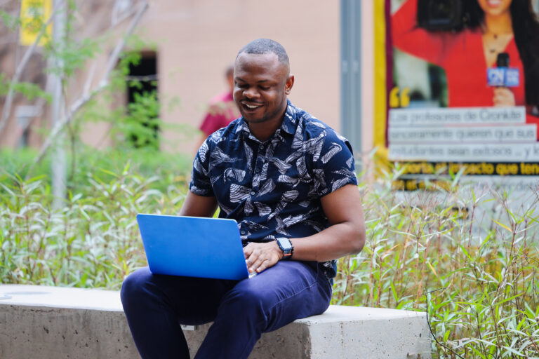 Cronkite Alum Kelechukwu Iruoma studying outside the Cronkite building in Phoenix.