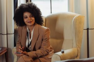 Female Black journalist smiling while holding a notepad