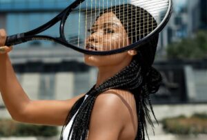 Tennis player holding racket up to her face