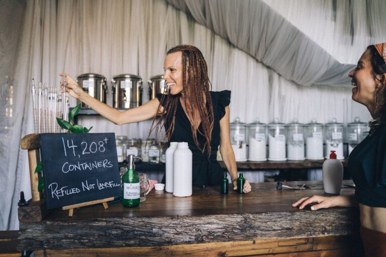 Saleswoman Taking a Pipette to Refill Bottles Brought by a Customer
