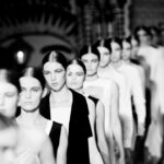 Female fashion models in line walking down runway