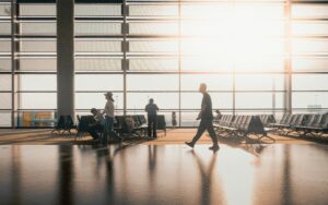 Travelers walk through airport terminal