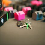 Miniature Model Houses with Keys on Desk