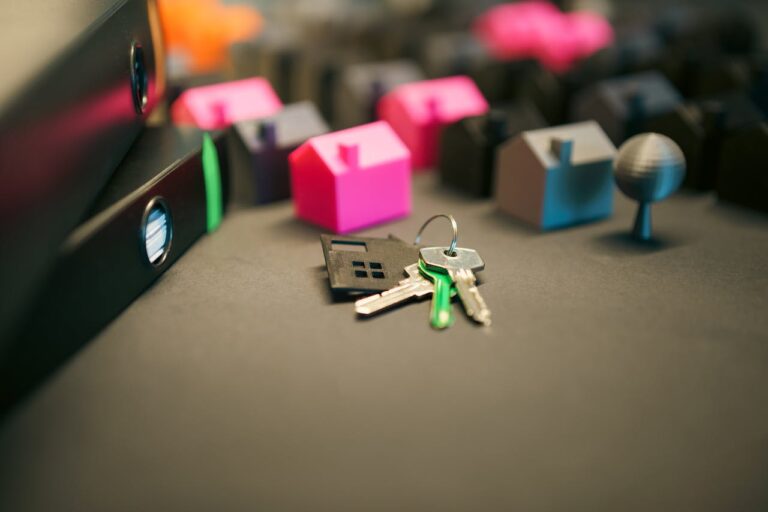 Miniature Model Houses with Keys on Desk