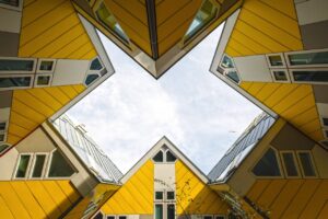 Low angles of several yellow houses with cloudy sky