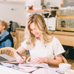 Woman Drawing an Art on a Book in a cafe