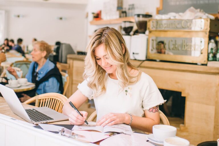 Woman Drawing an Art on a Book in a cafe