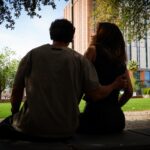 Two people sitting in a park laughing