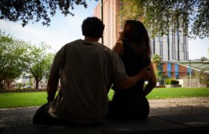 Two people sitting in a park laughing