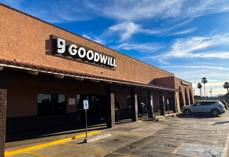 The outside of a Goodwill with a blue sky