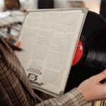 A Person Looking at a Vinyl Record inside a store