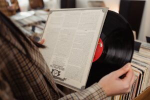 A Person Looking at a Vinyl Record inside a store