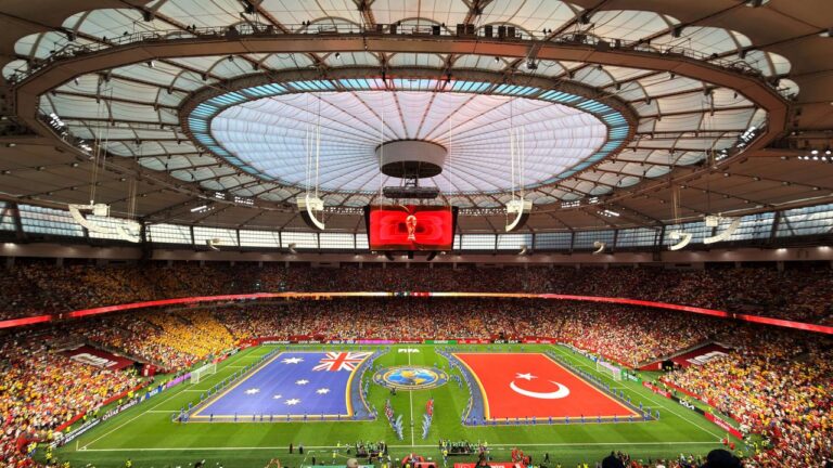 Vibrant soccer match at BC Place, Vancouver, showcasing international team flags.