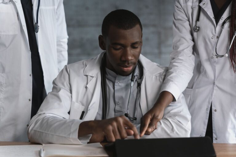 Doctors in discussion over a medical research project in a clinical setting.