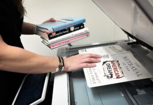 Woman making copies of books.