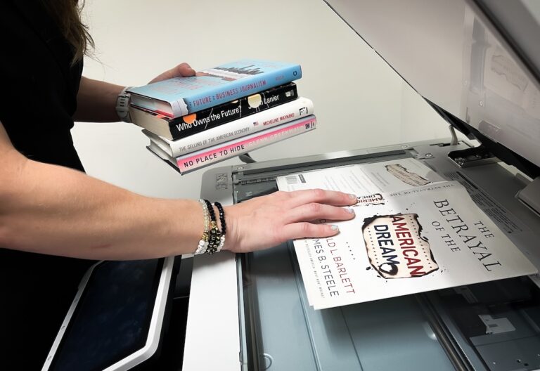 Woman making copies of books.